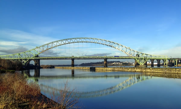 Runcorn green bridge with clear skies and a reflection on the river water of the bridge
